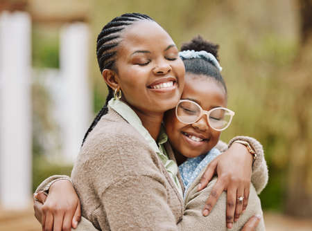 A mothers love. Cropped shot of an attractive young woman and her daughter embracing outdoors.