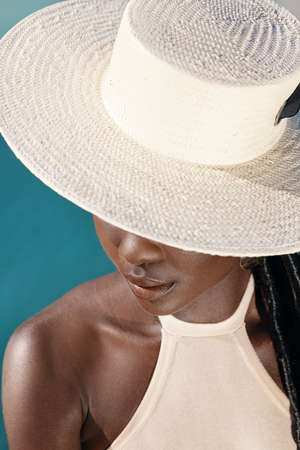 Shes a cultural trend. Studio shot of an attractive young woman posing against a blue background.の写真素材