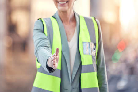 Its been a pleasure. Cropped shot of an unrecognizable female construction worker gesturing for a handshake while standing on a building site.の写真素材