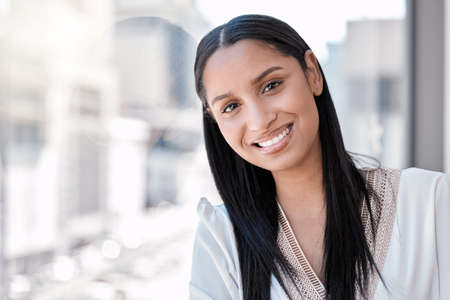 Ready to take the city. Shot of a young businesswoman taking a break from work.