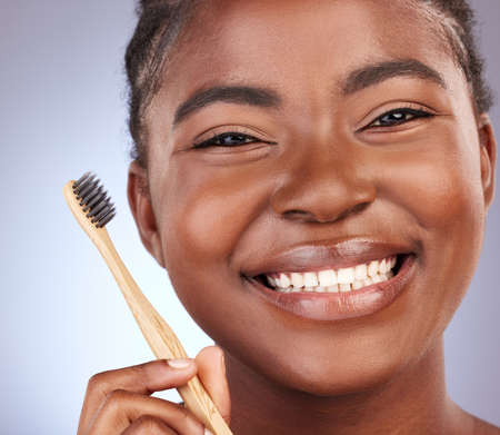 My smile is organic. Studio shot of a beautiful young woman brushing her teeth.