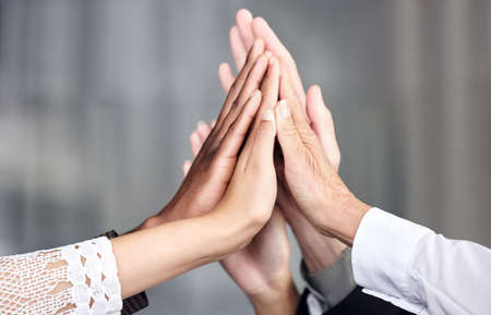 Getting down to business as a dedicated team. Closeup shot of a group of businesspeople joining...
