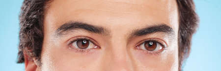 Eyes that peer into the soul. Shot of a closeup of a mans face against a studio background.の写真素材