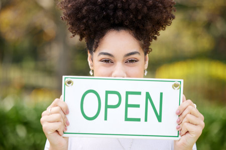 Place make a turn. Shot of a young woman holding a open outside.