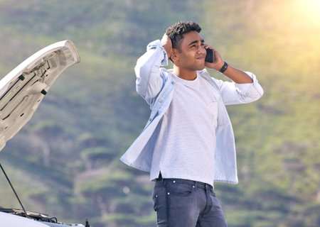 When can you guys get here. Cropped shot of a handsome young man on the phone with roadside...