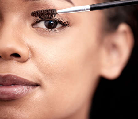 Lets accentuate these lashes. Closeup portrait of an attractive young woman applying mascara in the...