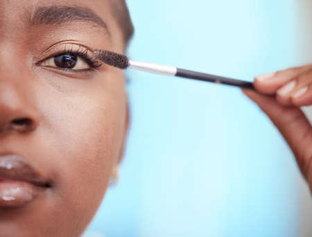 Im serious about this shade. Closeup portrait of an attractive young woman applying mascara in the bathroom at home.の写真素材