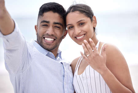 Were getting married. Cropped portrait of a young, newly betrothed couple showing off their...