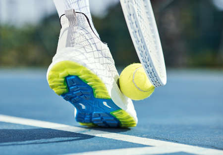 Only professionals pick up tennis balls this way. Cropped shot of an unrecognisable man using his...