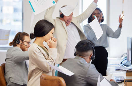 We just made our biggest sale yet. Shot of a diverse group of customer service agents celebrating a...