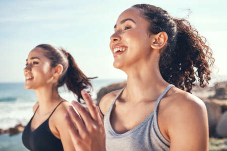 Improving our best time together. Shot of two beautiful young woman running together.の写真素材