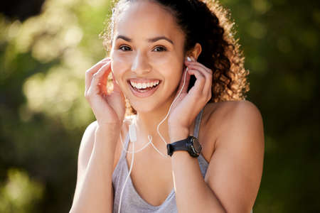 bringing my favourite album along with me. Shot of a young woman listening to music during a...