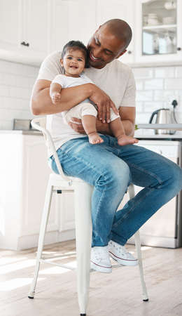 Her smile makes me smile. Shot of a young father and daughter spending time together at home.の写真素材