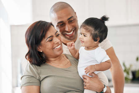 We cherish all these little moments. Shot of a young family spending time together at home.の写真素材
