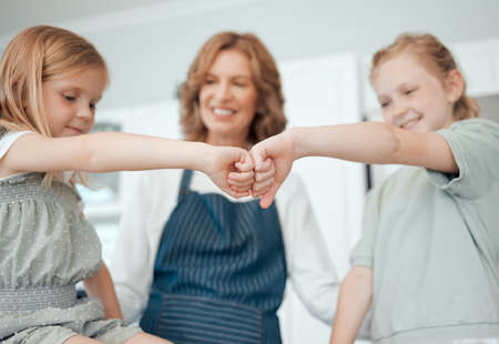 Lets make something delicious and cool. Closeup shot of two little girls giving each other a fist...