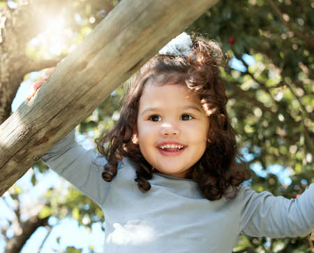 Having fun is what I do best. Shot of an adorable little girl playing outside.
