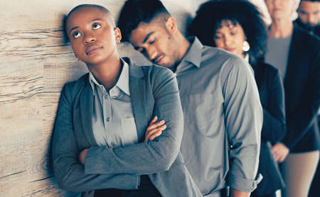 Once you have commitment, you need the discipline. Shot of a young businesspeople looking bored in a waiting room.の写真素材