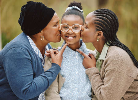 So much love in one picture. Cropped portrait of an adorable little girl being kissed on the cheeks...
