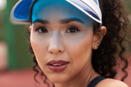 I come to the court looking like a winner. Closeup shot of a female tennis player standing outside.の写真素材