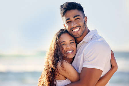 He surprises me whenever he can. a couple enjoying a day at the beach.の写真素材