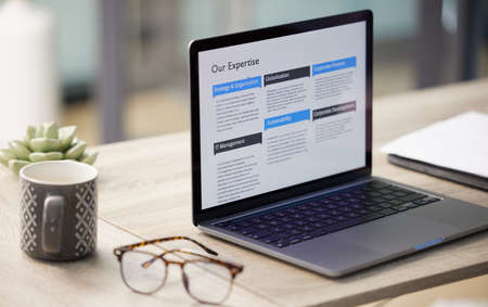 Your tools dictate your success. a laptop on a desk in an empty office.の写真素材