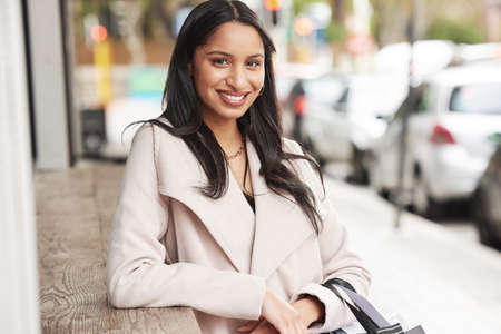These city streets welcome me. a woman taking a break during a shopping trip.