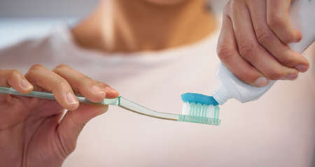 Brush twice a day to prevent gum disease. an unrecognisable woman brushing her teeth at home.