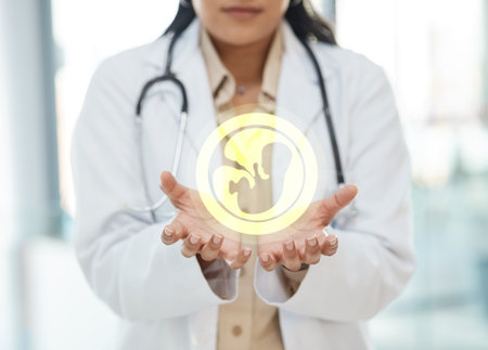 Caring for you is simply what we do. a unrecognizable doctor holding a image of a fetus in a hospital.の写真素材