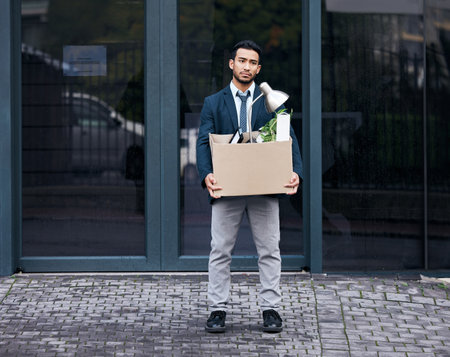 Everything you want is on the other side of fear. a young businessman looking depressed after being retrenched from work.の写真素材