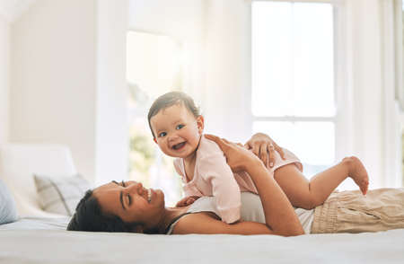 A mothers love. an attractive young woman and her newborn baby at home.