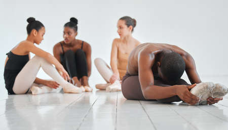 Today a studio, tomorrow a stage. a young boy practicing his ballet routine with his classmates in...