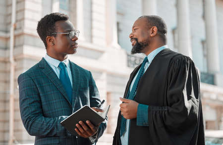 Learning from the best. two male lawyers talking in the city.