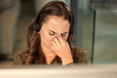 I give up. a young call centre agent looking stressed out while working in an office.