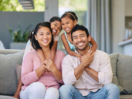 Theyre our little angels. a young family relaxing together at home.の写真素材