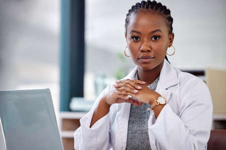 The doctor is ready to see you now. a female doctor working on her laptop.