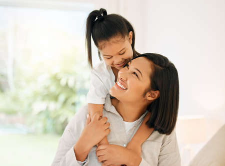 a young mother and daughter bonding together at home.の写真素材