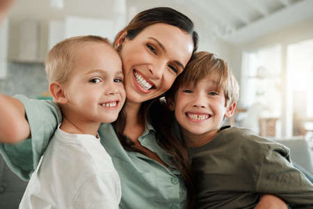 Give me your biggest smile. a family relaxing together at home.の写真素材