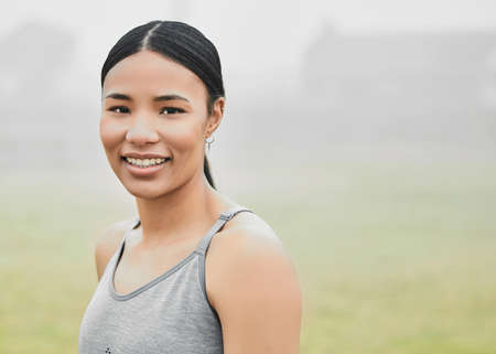 Working out always puts me in a good mood. Cropped portrait of an attractive young female athlete exercising outside.の写真素材