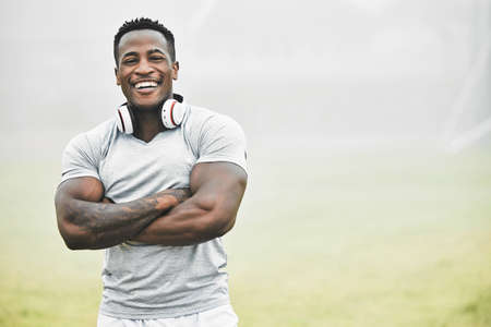 Ive got confidence in the process. Cropped portrait of a handsome young male athlete standing with his arms folded while exercising outside.の写真素材