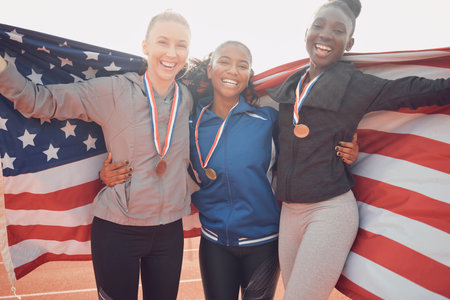 Cherish the team you have. a group of female athletes holding an american flag.の写真素材