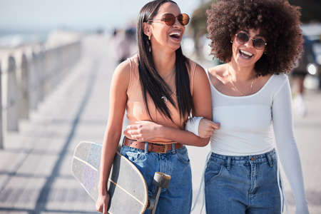 I dont know whats tighter - our jeans or our friendship. two young friends hanging out at the promenade.の写真素材
