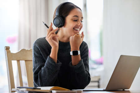 Sounds good to me. an attractive young female entrepreneur working on her laptop at home.