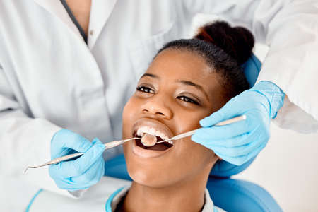 Healthy gums mean a healthy mouth. a young female patient having her teeth examined.の写真素材
