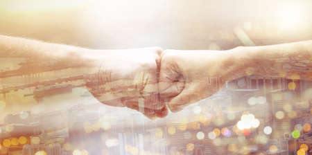 We stand united. two unrecognizable people giving each other a fist bump.の写真素材