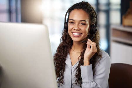 Im always here to help. a young businesswoman working in a call center.