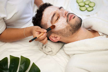 Its my first spa day but definitely not my last. a handsome young man enjoying a facial at a spa.