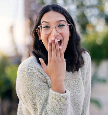Ive been waiting for this. Closeup shot of woman looking surprised while standing outside.の写真素材