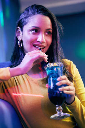 Come for the cocktails, stay for the vibe. a young woman having cocktails on a fun night out.