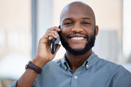 Success is liking yourself. a young businessman using a smartphone in a modern office.の写真素材