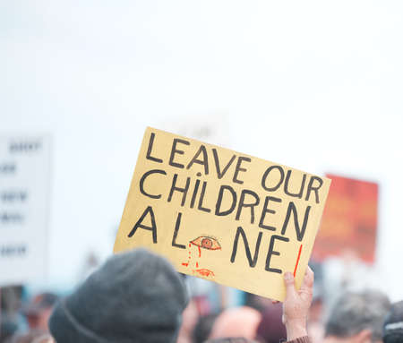 Protect your family. Cape Town, South African - October 2, 2021 Unrecognisable demonstrators holding...